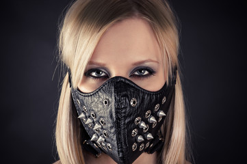 portrait of a woman in a mask with spikes