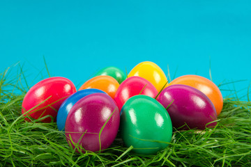 easter eggs in busket on green gras isolated