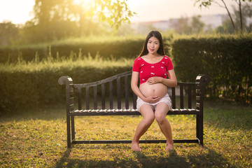 Image of pregnant woman touching her belly with hands