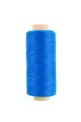 bobbin of blue thread isolated on the background