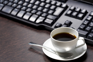 Fototapeta na wymiar Keyboard and a cup of coffee