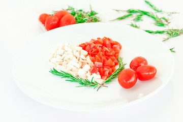 tomato and mushroom with rosemary on plate in the shape of heart