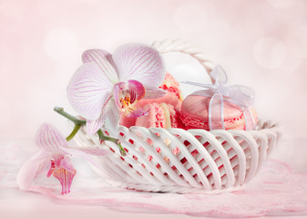 French macarons with orchid on pink background background.