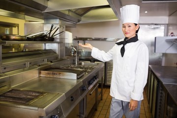 Confident female cook in the kitchen