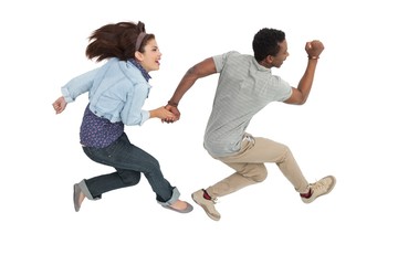 Fototapeta na wymiar Side view of a cheerful couple jumping