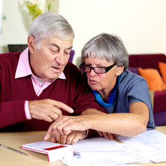 Elderly couple working with documents and taxes