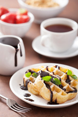 Belgian waffles with chocolate and powder sugar for breakfast