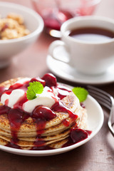 pancakes with cherry jam and cream for breakfast