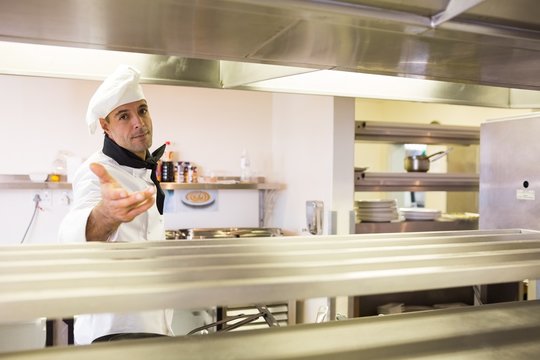 Confident male chef standing in kitchen