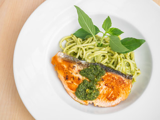 Spaghetti and salmon in pesto sauce
