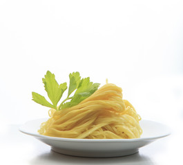 chinese yellow eggs noodle on white disk with green leaves of ce