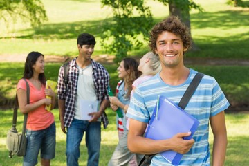 Boy with college friends in background at campus