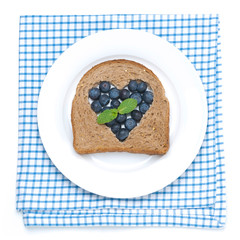 a piece of bread with the middle filled with blueberries
