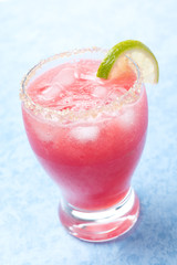 glass of watermelon cocktail with brown sugar and lime