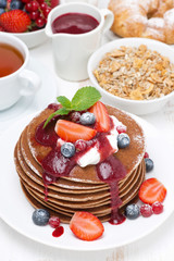 pancakes with cream, fruit sauce, berries for breakfast