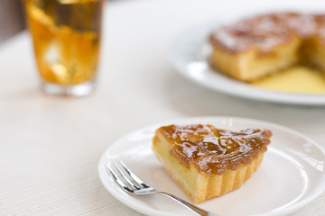 Tart cake cut into piece and iced tea 
