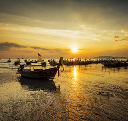 Traditional thai boats at sunset beach. Ao Nang, Krabi province
