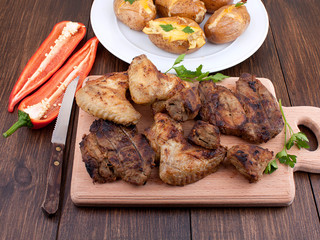 Barbecue grilled steaks; chicken wings and baked potato
