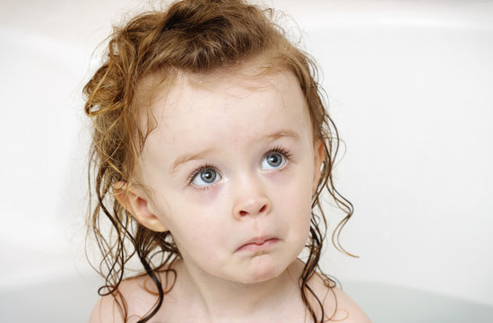 Frightened little girl in the bath