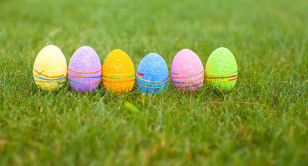 Colored colorful easter eggs in the grass