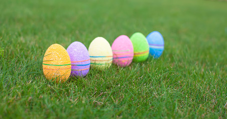 Multi-colored Easter eggs on green grass