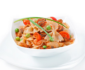 Farfalle pasta with seafood, cherry tomatoes and green peas