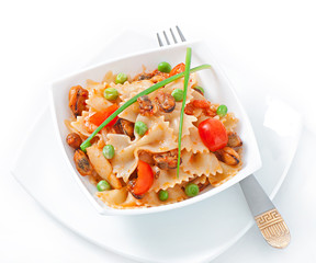 Farfalle pasta with seafood, cherry tomatoes and green peas