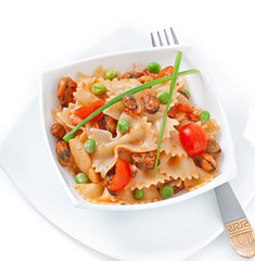 Farfalle pasta with seafood, cherry tomatoes and green peas