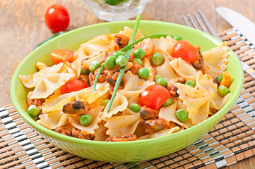Farfalle pasta with seafood, cherry tomatoes and green peas