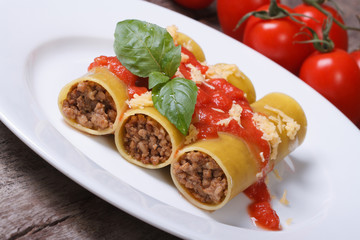 cannelloni stuffed with meat and tomato sauce and cheese
