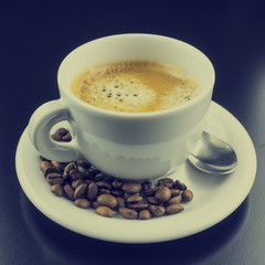 Cup of hot frothy espresso coffee