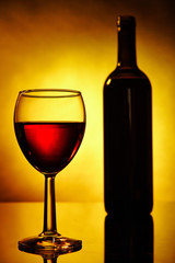 Glass of red wine and a bottle