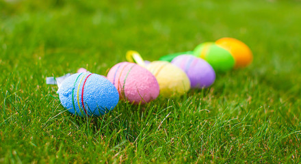 Fototapeta na wymiar Multi-colored Easter eggs on green grass