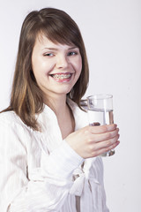 young woman with glass of water on a white