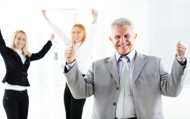 Success senior businessman showing thumbs up
