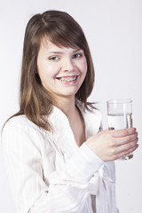young woman with glass of water on a white