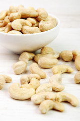 Cashew nuts on wood and in a bowl