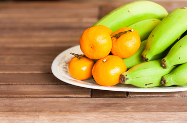 Orange an banana on the table