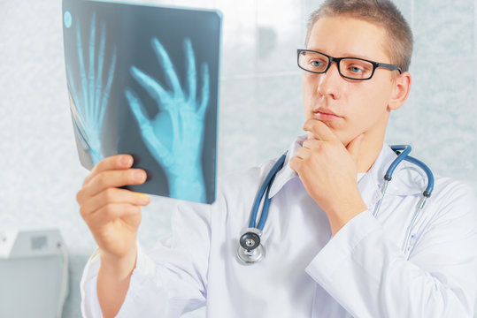 Physician looks at x-ray image