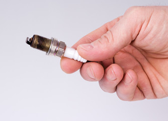Hand man holding a spark plug
