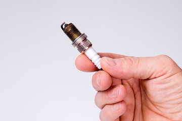 Hand man holding a spark plug
