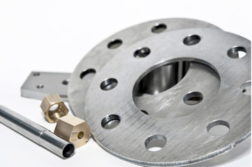 Closeup metal flanges and brass nuts.