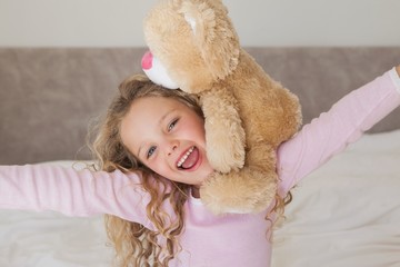 Young happy girl with stuffed toy