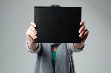Woman showing blank black cover