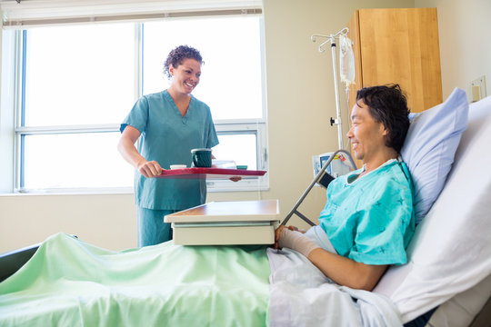 Nurse Bringing Breakfast For Patient In Hospital - Powered by Adobe