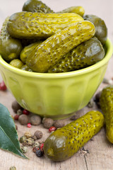 pickled cucumbers in a green bowl