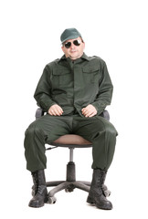 Worker in glasses sitting on chair.