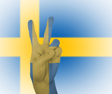 Hand peace sign with flag of Sweden