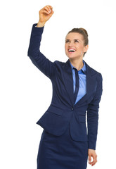 Happy business woman writing in air with pen