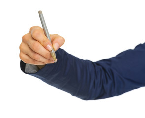 Closeup on business woman hand writing in air